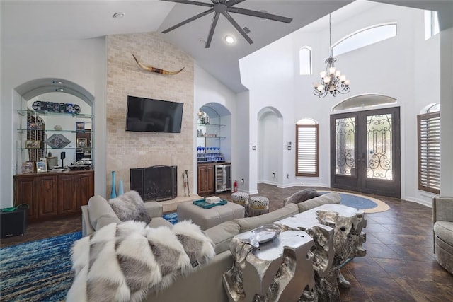 15203 Lariat Trl, Austin, TX 78734 - living room featuring wine cooler, a large fireplace, high vaulted ceiling, ceiling fan, and french doors