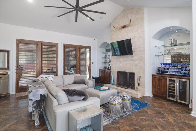 15203 Lariat Trl, Austin, TX 78734 - living area featuring a ceiling fan, beverage cooler, high vaulted ceiling, a dry bar, and dark stone finish flooring
