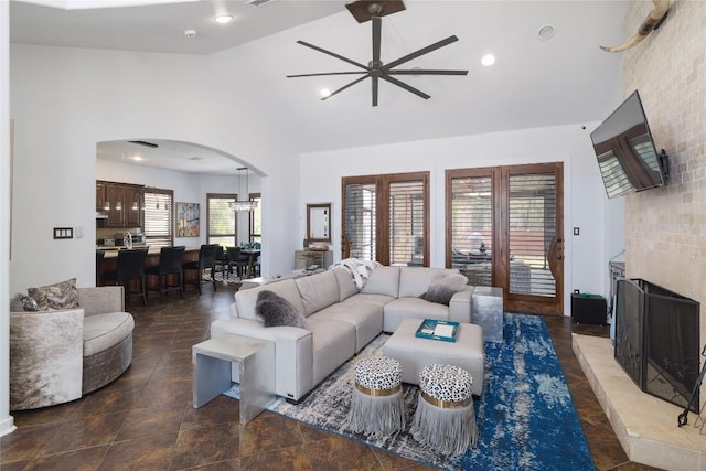 15203 Lariat Trl, Austin, TX 78734 - living area with ceiling fan, arched walkways, high vaulted ceiling, and a fireplace