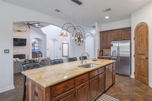 15203 Lariat Trl, Austin, TX 78734 - kitchen featuring appliances with stainless steel finishes, arched walkways, ceiling fan, and open floor plan