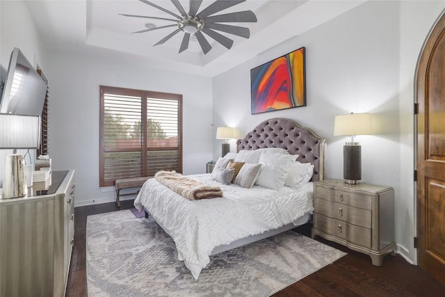 15203 Lariat Trl, Austin, TX 78734 - bedroom featuring a tray ceiling, dark wood-style flooring, and ceiling fan