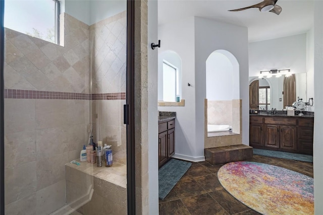 15203 Lariat Trl, Austin, TX 78734 - bathroom with vanity, a bath, a tile shower, and ceiling fan