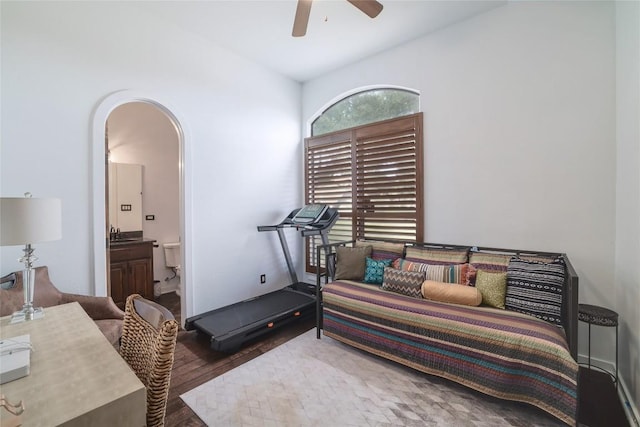 15203 Lariat Trl, Austin, TX 78734 - bedroom featuring arched walkways, ensuite bathroom, wood finished floors, and ceiling fan