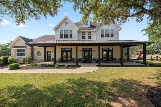 140 Vincas Shadow Ct, Driftwood, TX 78619 - view of front facade featuring french doors, a standing seam roof, and metal roof