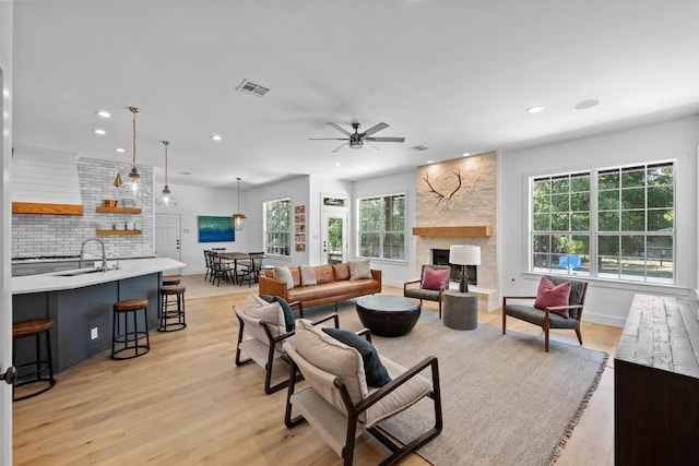 140 Vincas Shadow Ct, Driftwood, TX 78619 - living room featuring recessed lighting, ceiling fan, light wood-style flooring, a fireplace, and baseboards