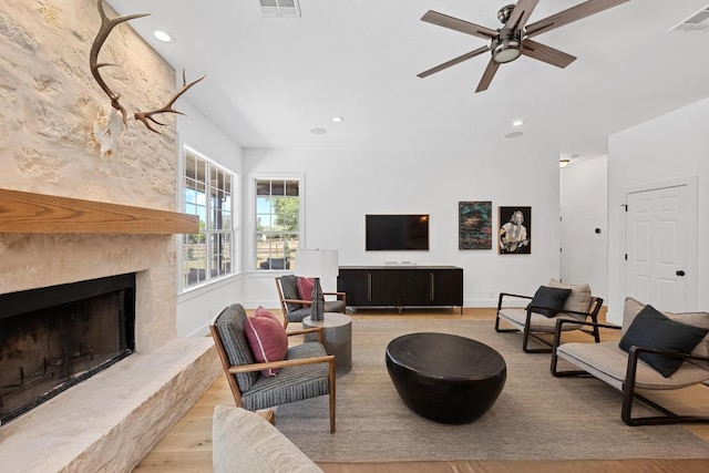 140 Vincas Shadow Ct, Driftwood, TX 78619 - living room with wood finished floors, ceiling fan, recessed lighting, and a large fireplace