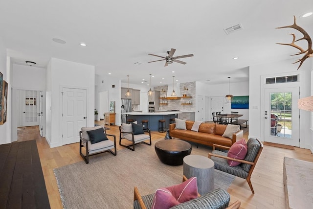140 Vincas Shadow Ct, Driftwood, TX 78619 - living area featuring light wood finished floors, a ceiling fan, and recessed lighting
