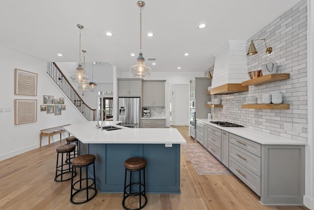140 Vincas Shadow Ct, Driftwood, TX 78619 - kitchen featuring a sink, stainless steel fridge, gray cabinetry, gas stovetop, and open shelves