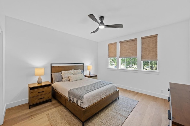 140 Vincas Shadow Ct, Driftwood, TX 78619 - bedroom with baseboards, light wood finished floors, and a ceiling fan