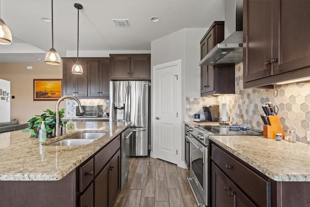 308 First Down Dash, Burnet, TX 78611 - kitchen with wall chimney exhaust hood, stainless steel appliances, a sink, and dark brown cabinetry