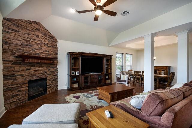 3200 Argento Pl, Cedar Park, TX 78613 - living room with decorative columns, a ceiling fan, a fireplace, baseboards, and lofted ceiling