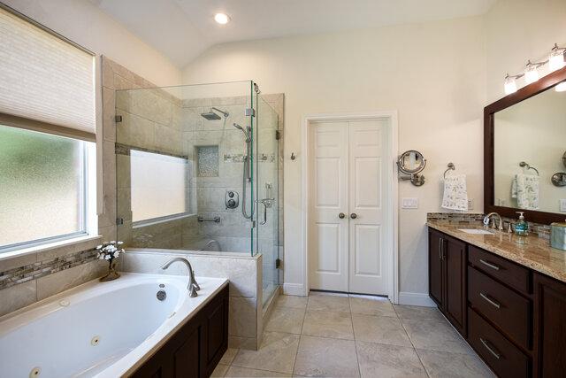 3200 Argento Pl, Cedar Park, TX 78613 - bathroom featuring a tub with jets, a shower stall, vanity, lofted ceiling, and tile patterned floors