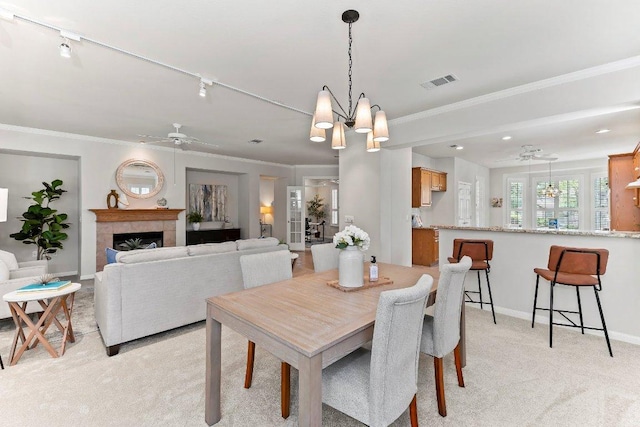 103 Winecup Way, Georgetown, TX 78633 - dining area featuring a ceiling fan, light colored carpet, baseboards, a chandelier, and crown molding