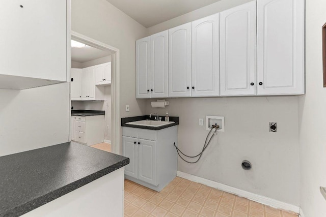 103 Winecup Way, Georgetown, TX 78633 - laundry area featuring light flooring, hookup for a washing machine, baseboards, cabinet space, and hookup for an electric dryer