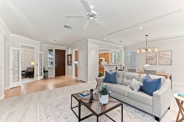 103 Winecup Way, Georgetown, TX 78633 - living room with french doors, a chandelier, light tile patterned floors, baseboards, and ornamental molding