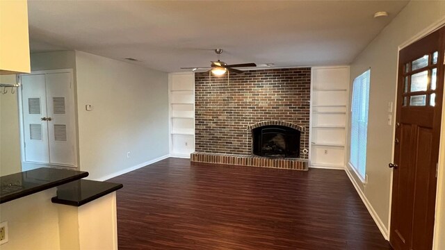 3307 Whitepine Dr, Austin, TX 78757 - unfurnished living room featuring a ceiling fan, built in features, baseboards, dark wood-style floors, and plenty of natural light