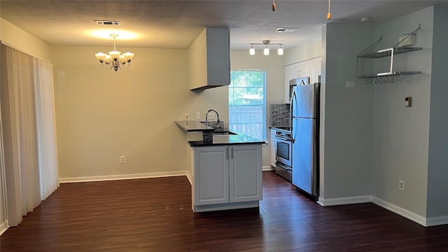 3307 Whitepine Dr, Austin, TX 78757 - kitchen featuring a sink, stainless steel appliances, a chandelier, dark wood-style flooring, and white cabinetry