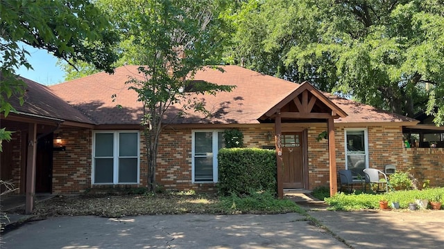 3307 Whitepine Dr, Austin, TX 78757 - view of front of property featuring brick siding and roof with shingles