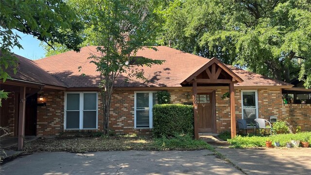 3307 Whitepine Dr, Austin, TX 78757 - view of front of house featuring brick siding and roof with shingles