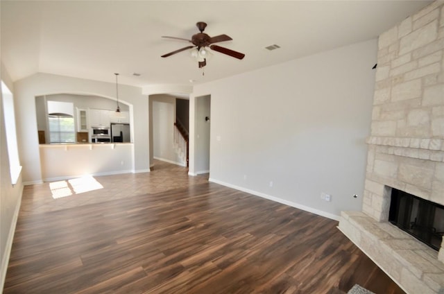 12609 Lee Park Ln, Austin, TX 78732 - unfurnished living room with ceiling fan, stairway, a fireplace, dark wood-style floors, and baseboards