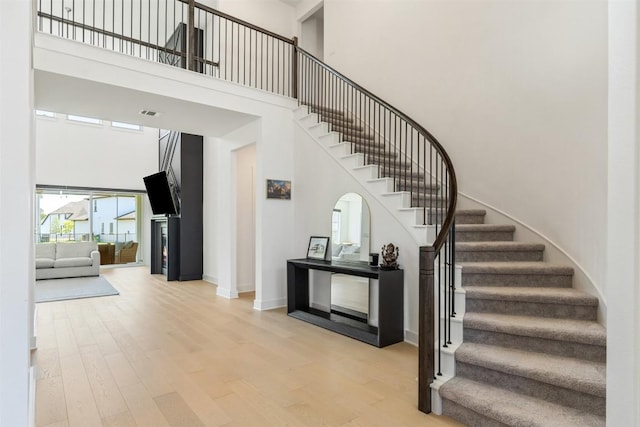 2905 Canto Trce, Leander, TX 78641 - stairway featuring a high ceiling, wood finished floors, and baseboards