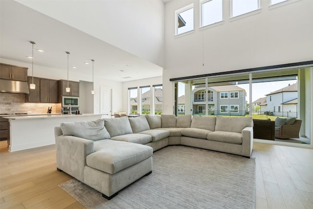2905 Canto Trce, Leander, TX 78641 - living room featuring light wood finished floors, healthy amount of natural light, a high ceiling, and recessed lighting