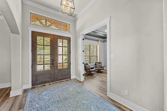 101 Aldea St, Georgetown, TX 78633 - foyer entrance with french doors, crown molding, healthy amount of natural light, and wood finished floors