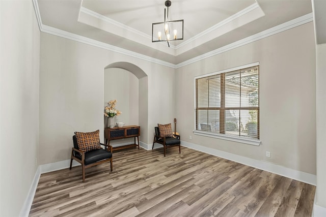 101 Aldea St, Georgetown, TX 78633 - sitting room with wood finished floors, a chandelier, a raised ceiling, and crown molding