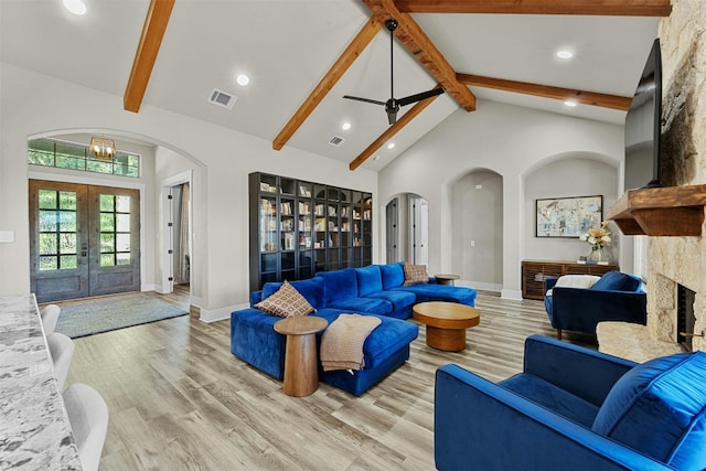 101 Aldea St, Georgetown, TX 78633 - living room with arched walkways, french doors, beamed ceiling, light wood-style floors, and recessed lighting