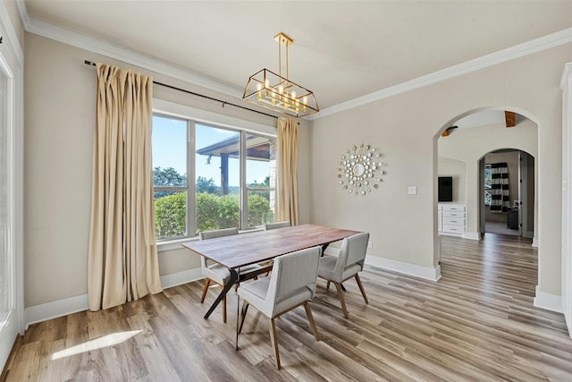 101 Aldea St, Georgetown, TX 78633 - dining space featuring light wood-type flooring, ornamental molding, a chandelier, and arched walkways