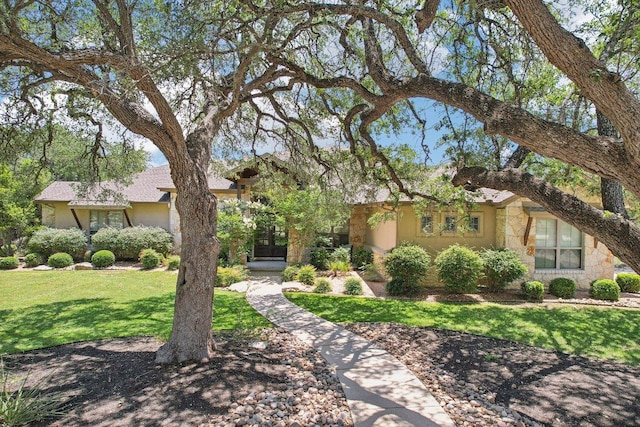101 Aldea St, Georgetown, TX 78633 - view of front of property with french doors, a front lawn, stone siding, and stucco siding