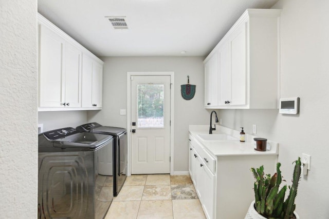 400 Goodnight Trl, Dripping Springs, TX 78620 - washroom featuring cabinet space, washing machine and clothes dryer, and light tile patterned flooring