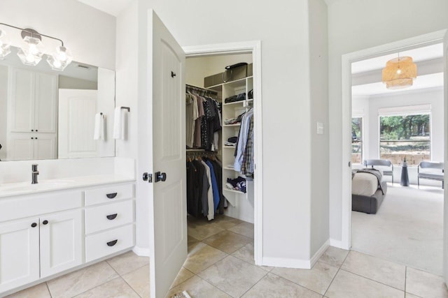 400 Goodnight Trl, Dripping Springs, TX 78620 - full bathroom featuring vanity, tile patterned floors, a walk in closet, and baseboards