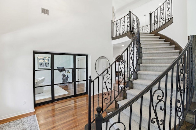 400 Goodnight Trl, Dripping Springs, TX 78620 - stairs featuring baseboards, wood finished floors, and a high ceiling