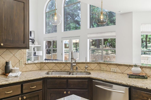 400 Goodnight Trl, Dripping Springs, TX 78620 - kitchen featuring dishwasher, a sink, dark brown cabinetry, decorative backsplash, and light stone countertops