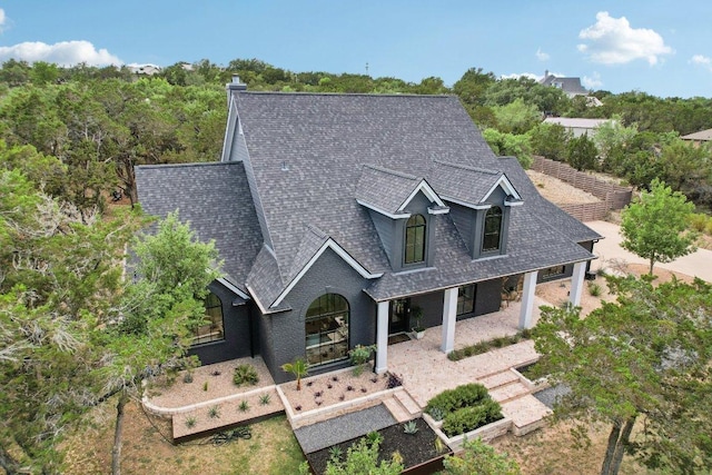 400 Goodnight Trl, Dripping Springs, TX 78620 - view of front facade featuring a shingled roof, a porch, and brick siding