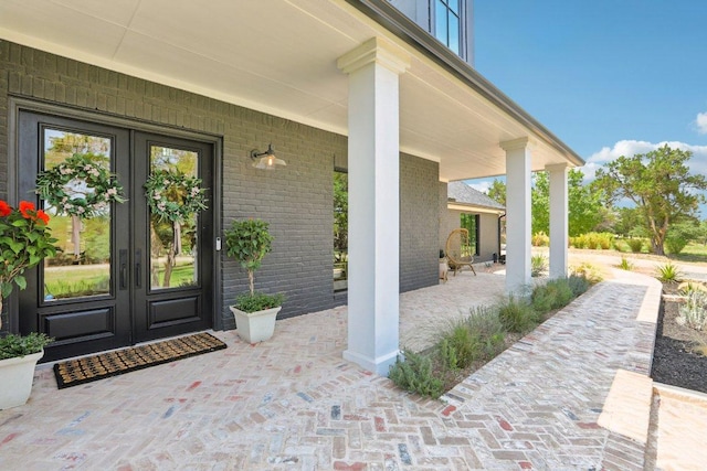 400 Goodnight Trl, Dripping Springs, TX 78620 - view of exterior entry with french doors, brick siding, and covered porch