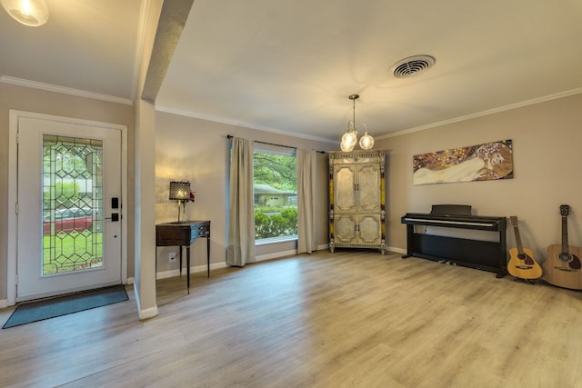 3002 Stardust Dr, Austin, TX 78757 - entryway featuring wood finished floors, crown molding, a chandelier, and baseboards
