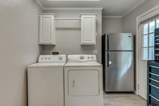 3002 Stardust Dr, Austin, TX 78757 - washroom featuring washing machine and clothes dryer, light wood-type flooring, ornamental molding, and cabinet space