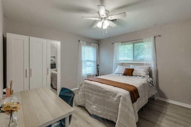 3002 Stardust Dr, Austin, TX 78757 - bedroom with baseboards, light wood-style flooring, ceiling fan, and a closet