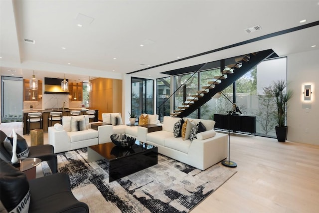 1115 Gillespie Pl, Austin, TX 78704 - living area with light wood finished floors, stairway, and recessed lighting