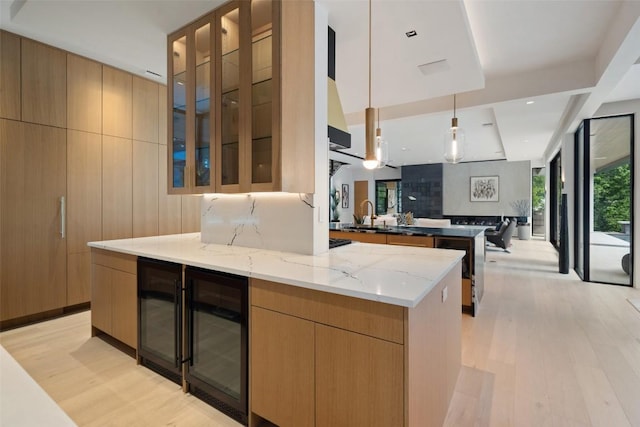 1115 Gillespie Pl, Austin, TX 78704 - kitchen with wine cooler, light wood-style flooring, and modern cabinets