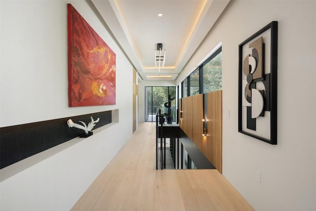 1115 Gillespie Pl, Austin, TX 78704 - corridor with wood finished floors, an upstairs landing, and a tray ceiling