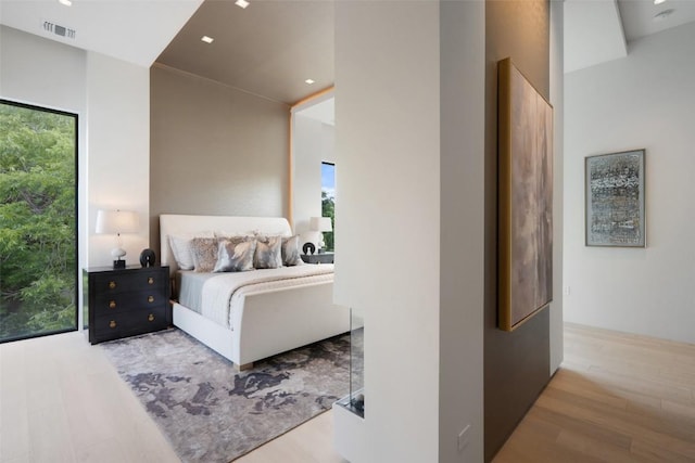 1115 Gillespie Pl, Austin, TX 78704 - bedroom with wood finished floors, multiple windows, and recessed lighting