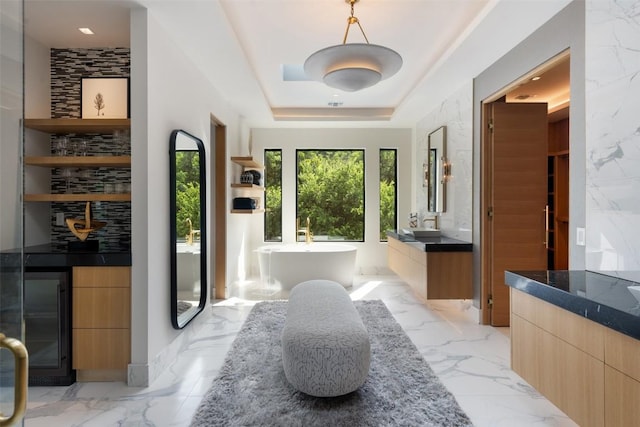 1115 Gillespie Pl, Austin, TX 78704 - full bathroom with vanity, marble tiled flooring, a freestanding bath, and a tray ceiling