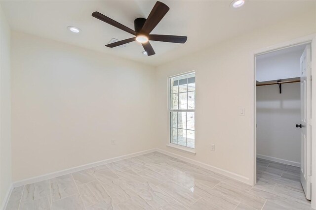 5403 Village Ln, Austin, TX 78744 - unfurnished bedroom featuring recessed lighting, a walk in closet, baseboards, ceiling fan, and a closet