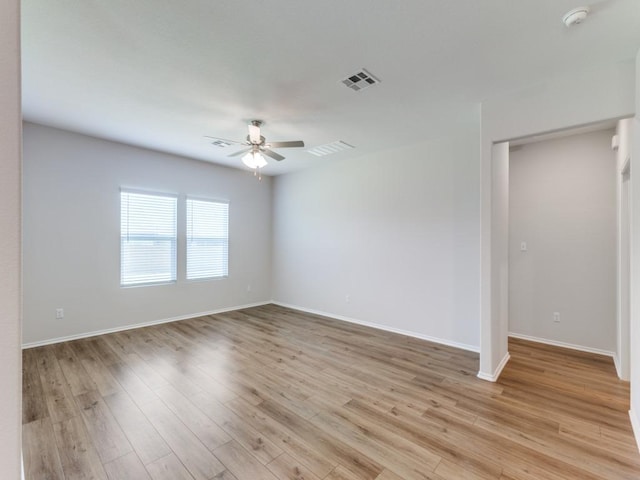 204 Magione St, Hutto, TX 78634 - spare room featuring a ceiling fan, a smoke detector, light wood-type flooring, and baseboards