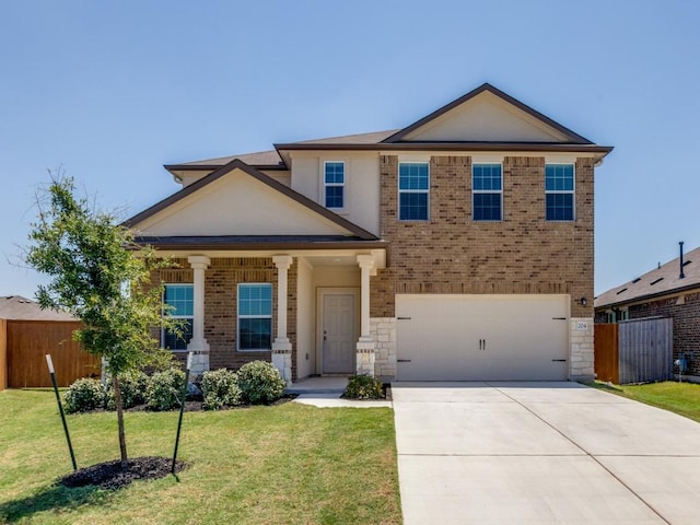 204 Magione St, Hutto, TX 78634 - view of front of home featuring a garage, driveway, brick siding, and stone siding