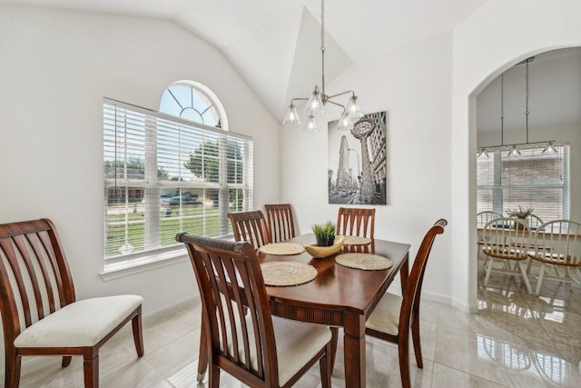 6015 Lone Star Ct, Hutto, TX 78634 - dining area featuring a chandelier, lofted ceiling, healthy amount of natural light, and light tile patterned flooring