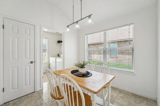 6015 Lone Star Ct, Hutto, TX 78634 - dining space with plenty of natural light, separate washer and dryer, lofted ceiling, baseboards, and light tile patterned flooring
